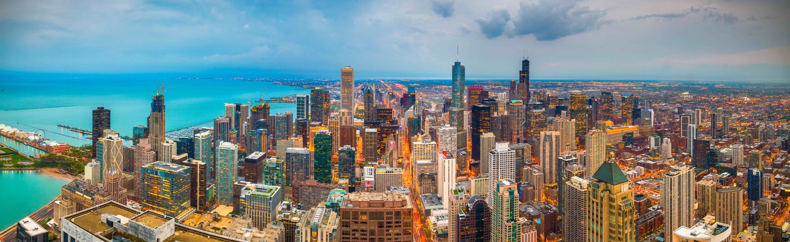 Aerial panorama of the Chicago skyline and lakefront at dusk